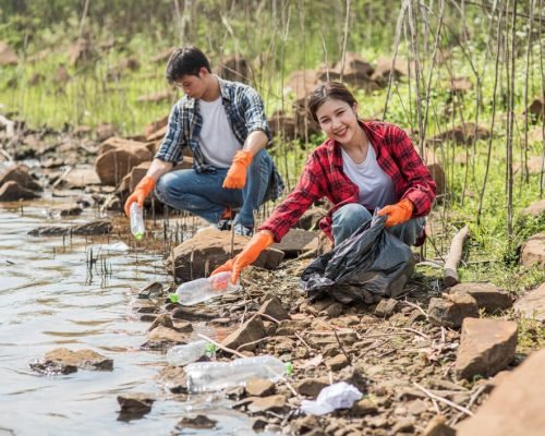 men-women-help-each-other-collect-garbage_1150-23974